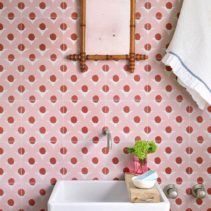 Bathroom wall with cement tiles featuring pink pattern